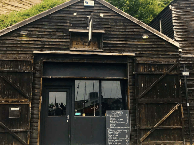Rock A Nore Kitchen is located in Hastings, East Sussex. The Good Food Guide says: “You can’t get much closer to the sea than this tiny, unassuming dining room housed in one of the tall, black, centuries-old fishermen’s sheds on the front in Hastings Old Town. It’s incredibly atmospheric. The ‘refreshingly succinct’ menu is chalked up on a board – all it tells you is what’s going to be on your plate and the price.”